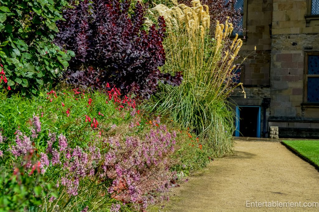 View of the formal gardens at Hardwick Hall, featuring manicured lawns and topiary.”