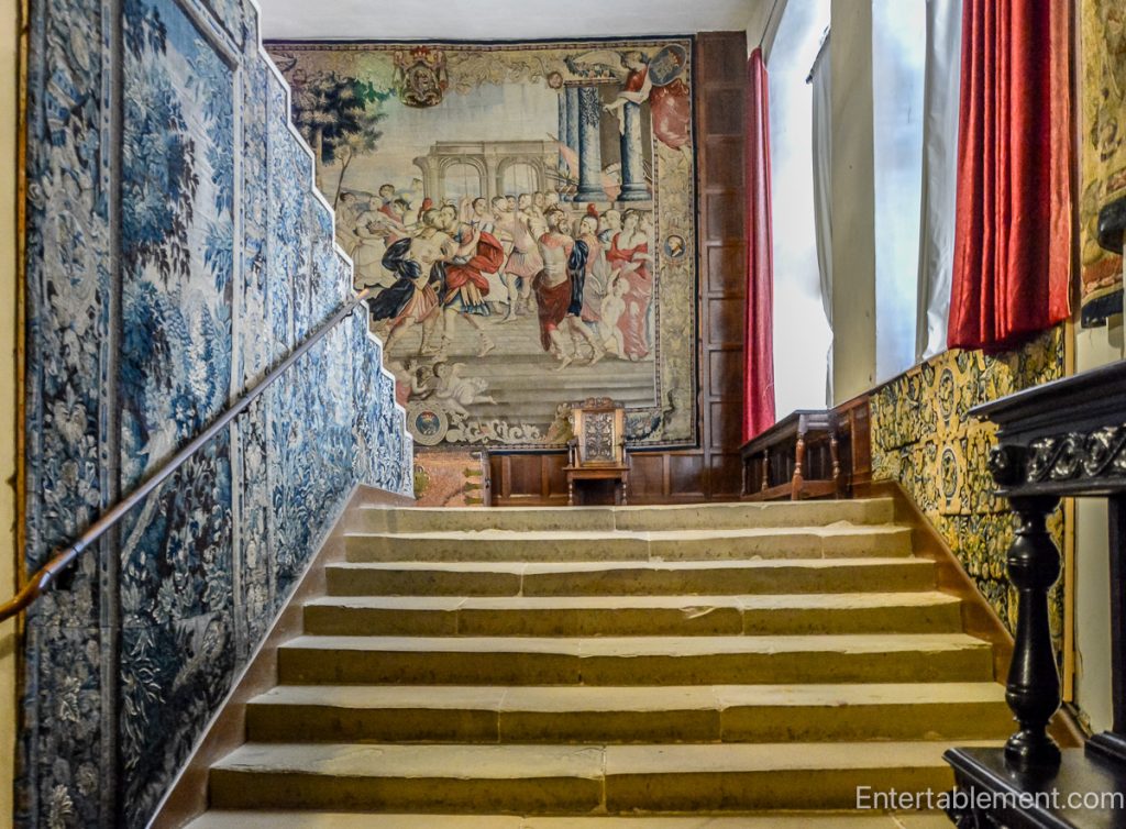 Room in Hardwick Hall displaying large 16th-century tapestries with intricate designs.