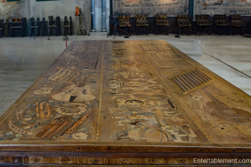 The Eglantine Table at Hardwick Hall, showcasing intricate inlaid designs of musical instruments and playing cards.