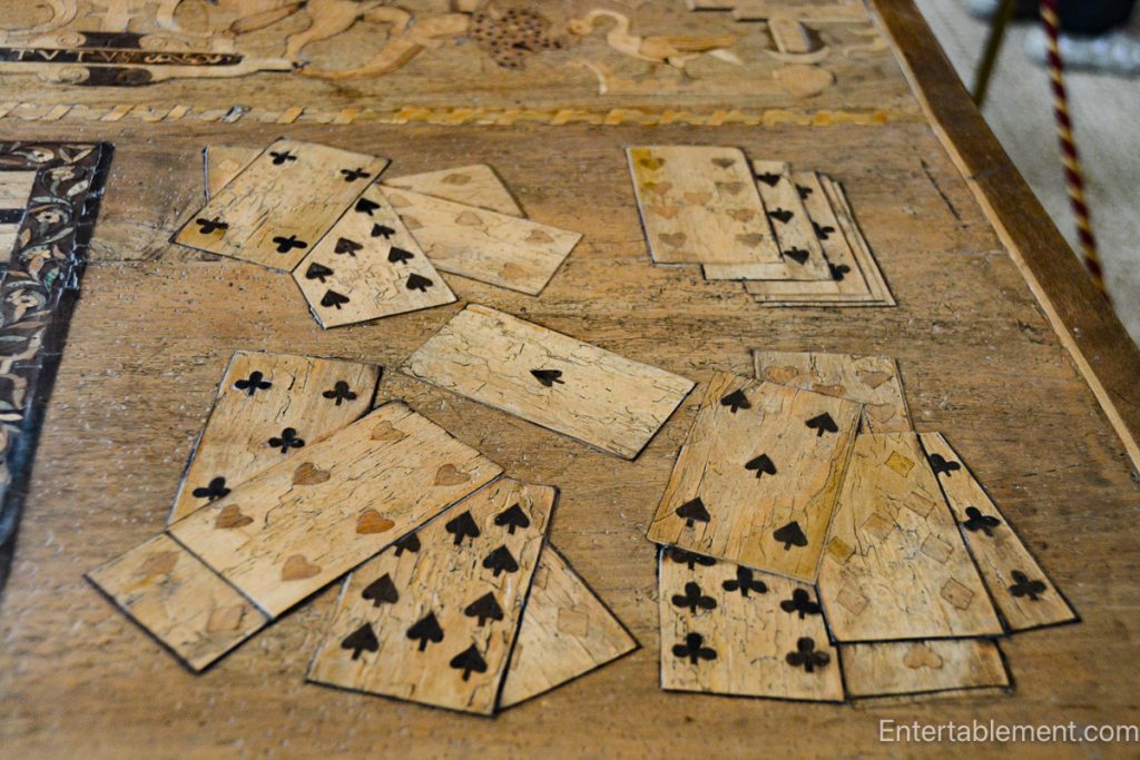 The Eglantine Table at Hardwick Hall, showcasing intricate inlaid designs of musical instruments and playing cards.