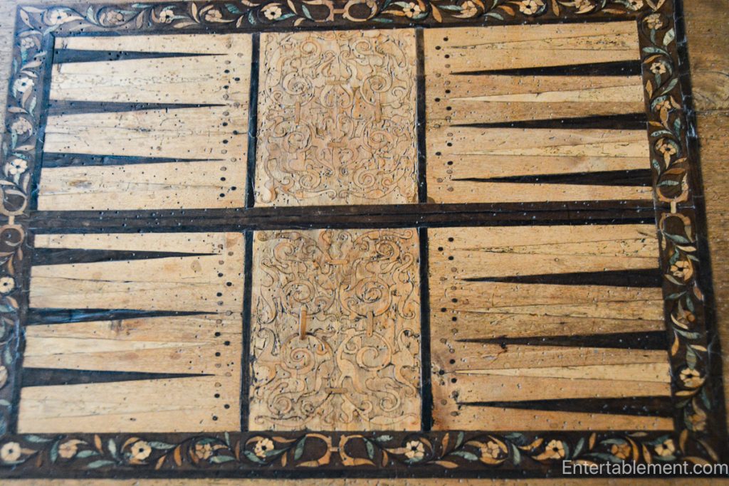 The Eglantine Table at Hardwick Hall, showcasing intricate inlaid designs of musical instruments and playing cards.