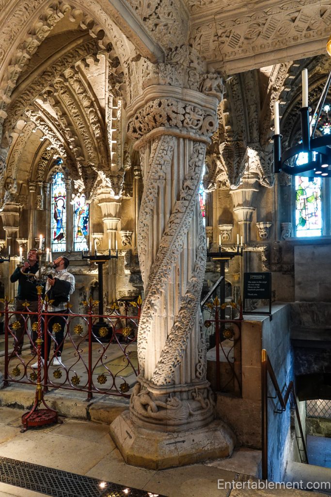 The ornate Apprentice Pillar with swirling vine designs inside Rosslyn Chapel.