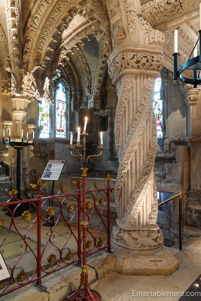 The ornate Apprentice Pillar with swirling vine designs inside Rosslyn Chapel.