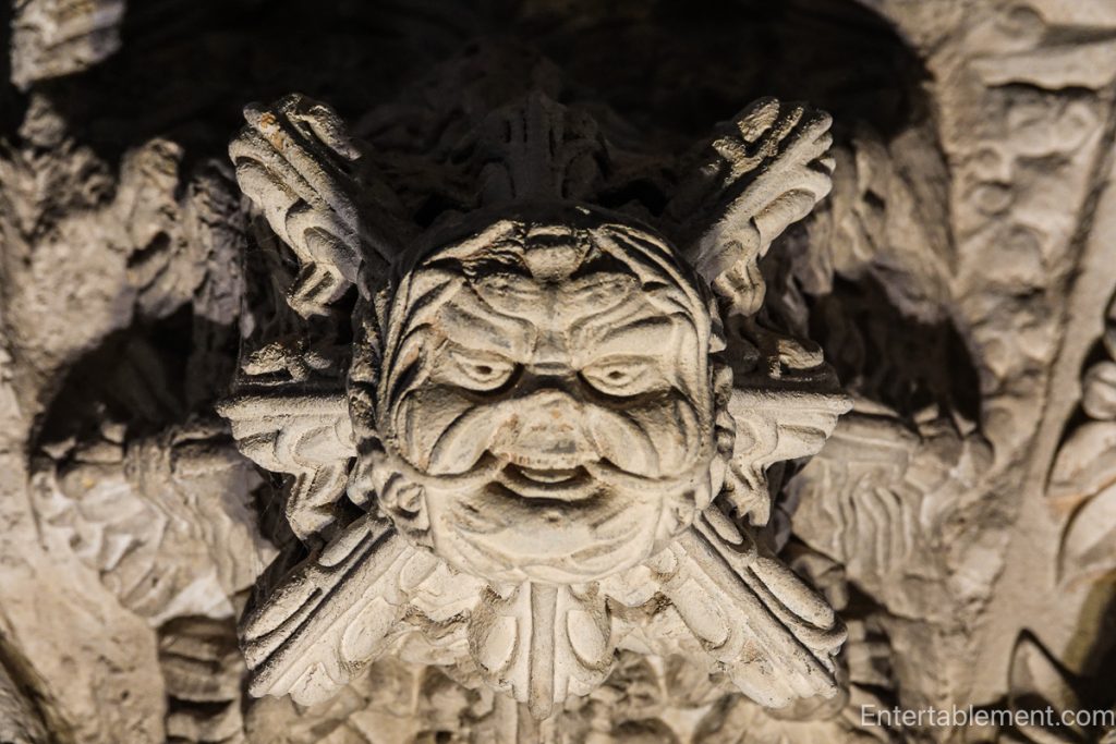 Close-up of a Green Man stone carving with foliage motifs at Rosslyn Chapel.