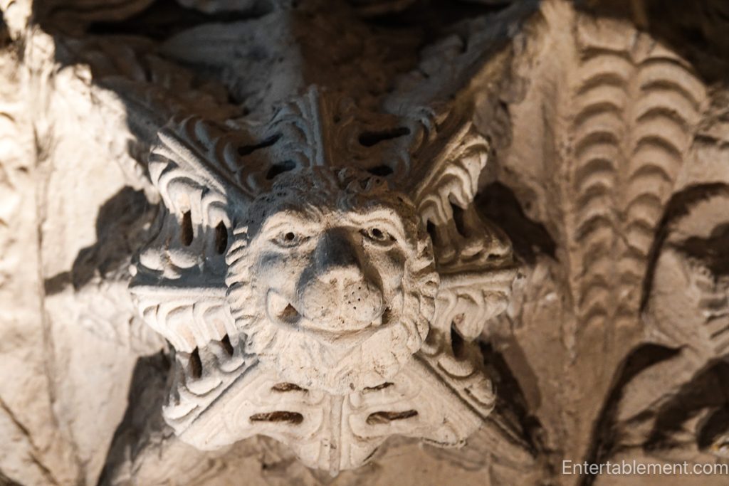 Close-up of a Green Man stone carving with foliage motifs at Rosslyn Chapel.