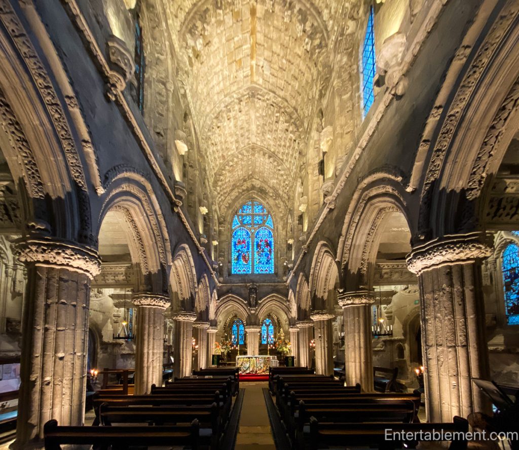 Intricate medieval stone carvings inside Rosslyn Chapel showing floral and symbolic motifs.