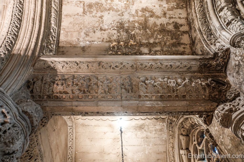 Medieval stone lintel depicting symbolic figures representing sin and mortality