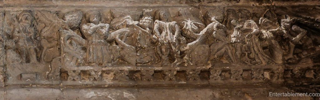 Medieval stone lintel depicting symbolic figures representing sin and mortality