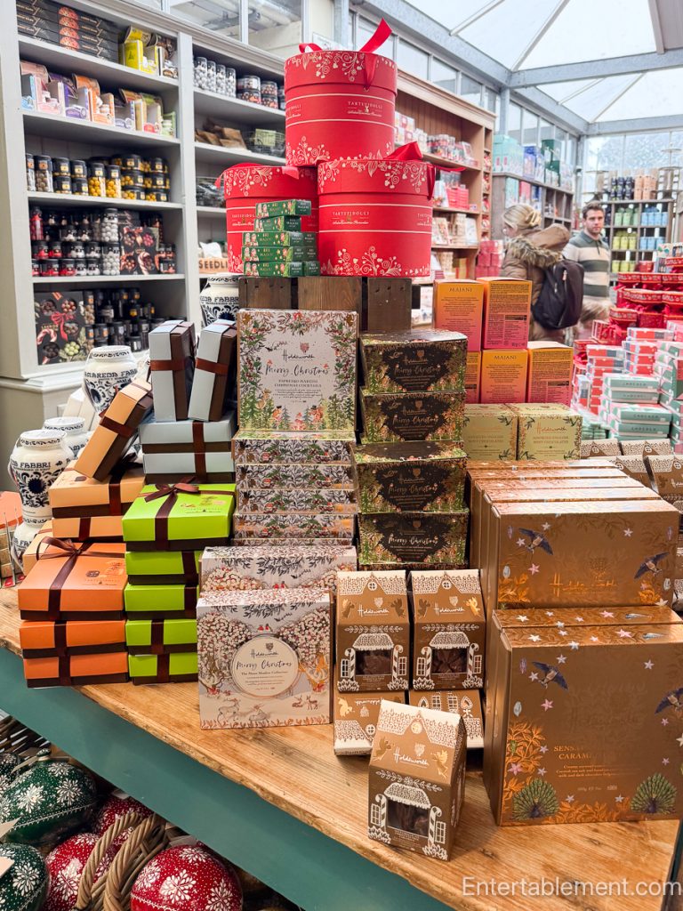 Elegant boxed chocolates with multicoloured truffles in a display case.