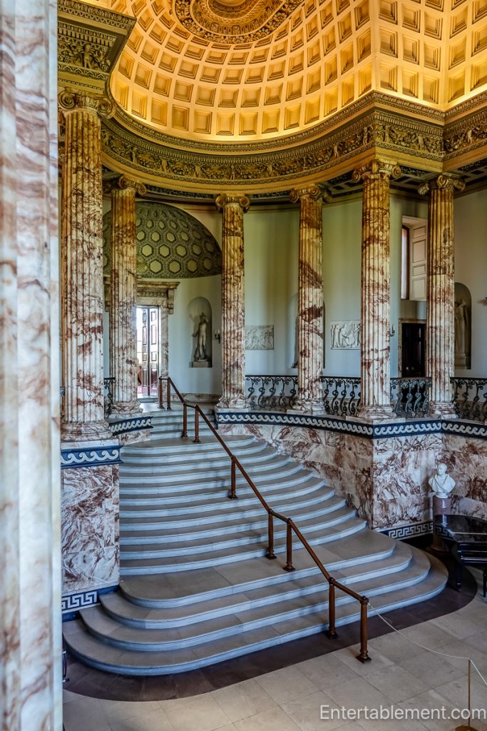 Marble Hall at Holkham Hall with coffered ceiling, classical statues in niches, and sweeping stone floor