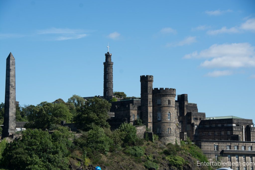 Nelson Monument, the National Monument and historic buildings on Calton Hill, Edinburgh, beneath a blue sky