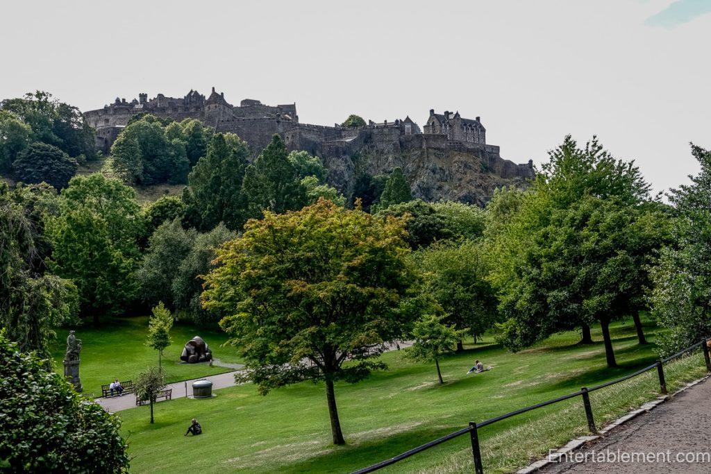 Edinburgh Castle rising above the lawns and mature trees of Princes Street Gardens
