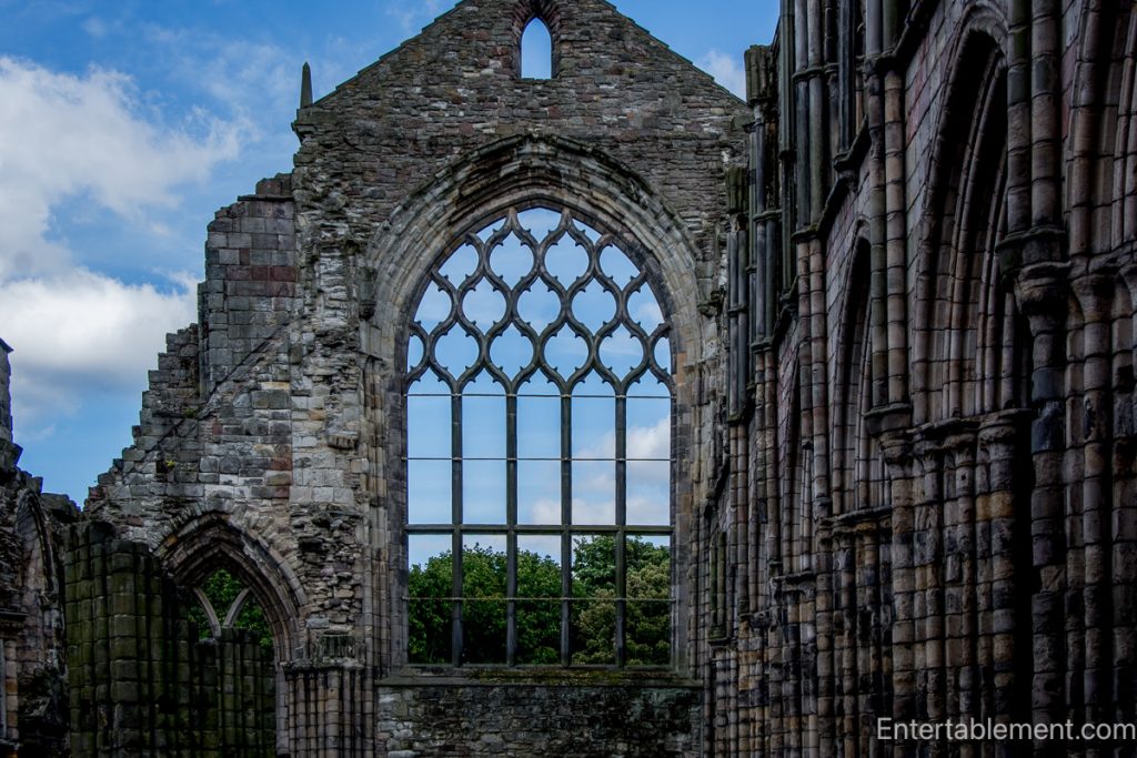 Large Gothic tracery window in the roofless stone ruins of Holyrood Abbey, Edinburgh