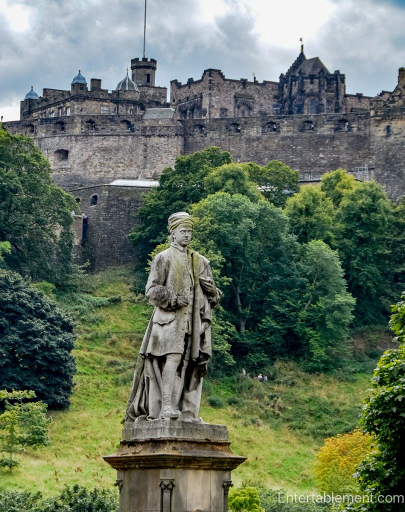 Statue of Scottish poet Allan Ramsay in West Princes Street Gardens, with Edinburgh Castle rising behind him.