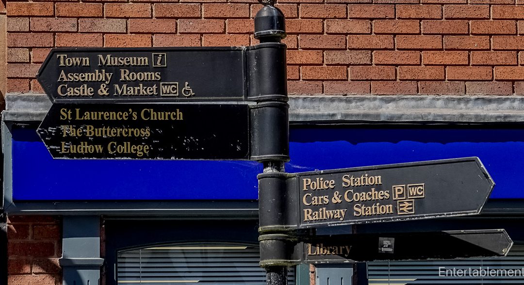 Direction signpost in Ludlow pointing to the castle, market, St Laurence's Church and other town landmarks
