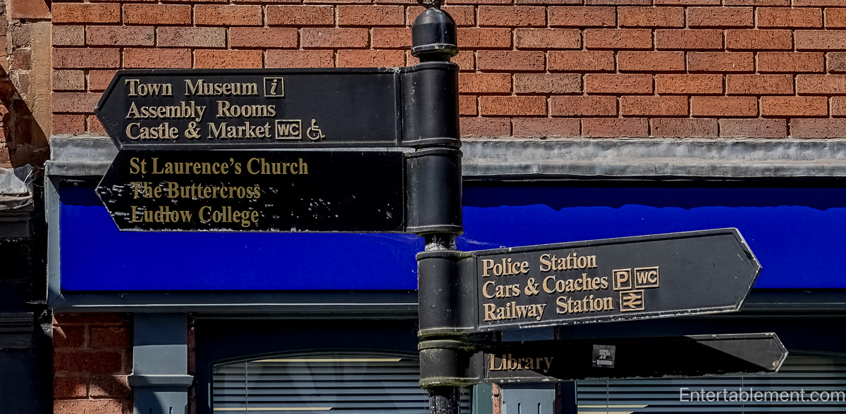 Direction signpost in Ludlow pointing to the castle, market, St Laurence's Church and other town landmarks
