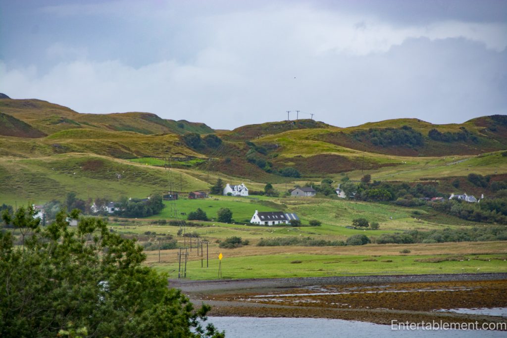 Green hills, scattered cottages and farmland beside a tidal inlet in the Scottish Highlands